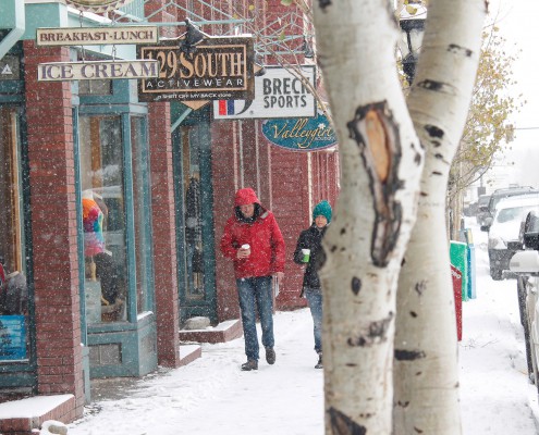 People walking down a snowy main street