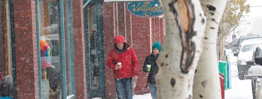 People walking down a snowy main street