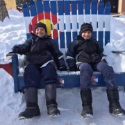Kids on a giant Colorado flag painted chair