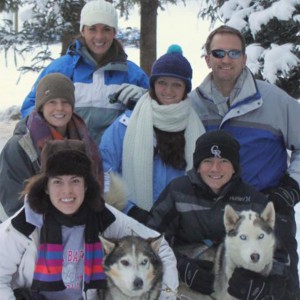 Group of people with sled dogs