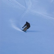 Snowboarder going down slope