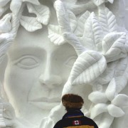 Person looking at a snow sculpture