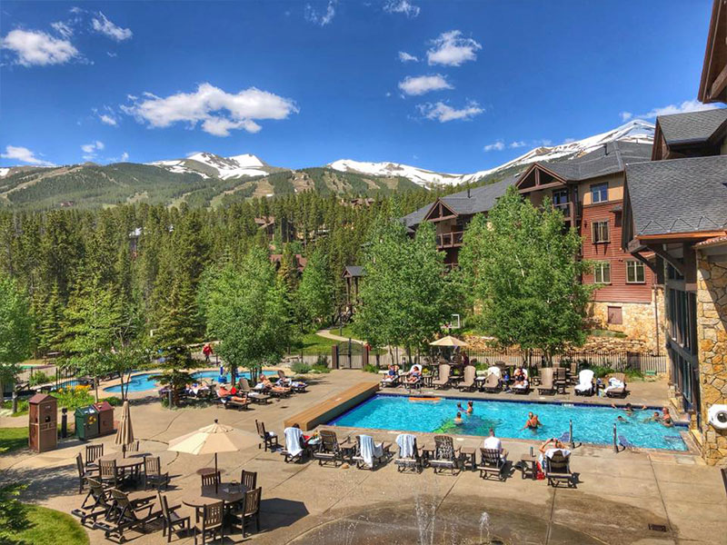 Grand Timber Lodge outdoor pool area with mountains in background