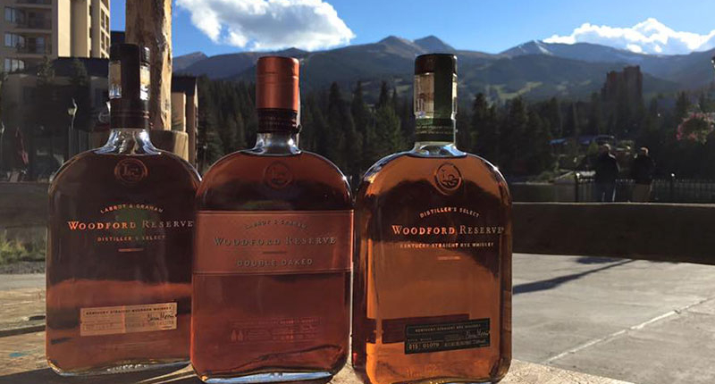 Bottles of bourbon with mountains in the background